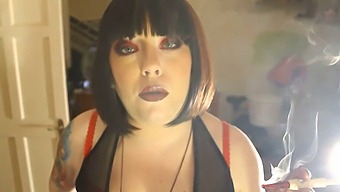 Domme Tina Smua Smokes A Filterless Cigarette While Holding A Lighter